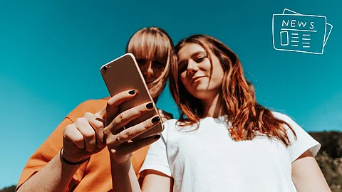 Zwei Frauen schauen sich die neusten Social Media News vom August 2026 an